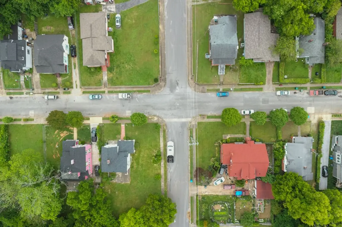 Overhead view of a residential street intersection with houses